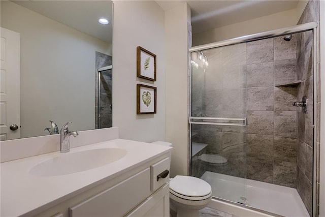 bathroom featuring walk in shower, oversized vanity, and toilet