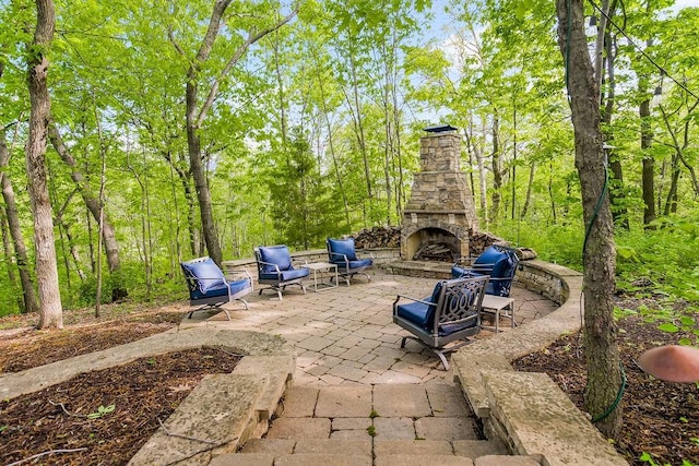 view of patio with an outdoor stone fireplace