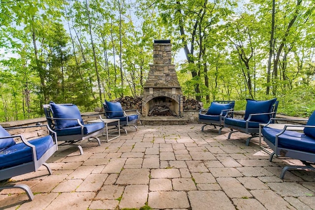 view of patio / terrace featuring an outdoor stone fireplace