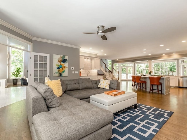 living room with crown molding, ceiling fan, and hardwood / wood-style floors