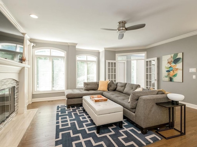 living room with crown molding, hardwood / wood-style flooring, and ceiling fan