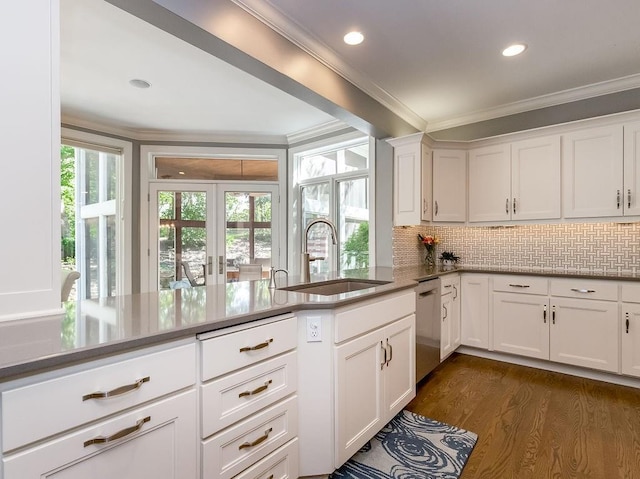 kitchen featuring white cabinetry, sink, ornamental molding, and dishwasher