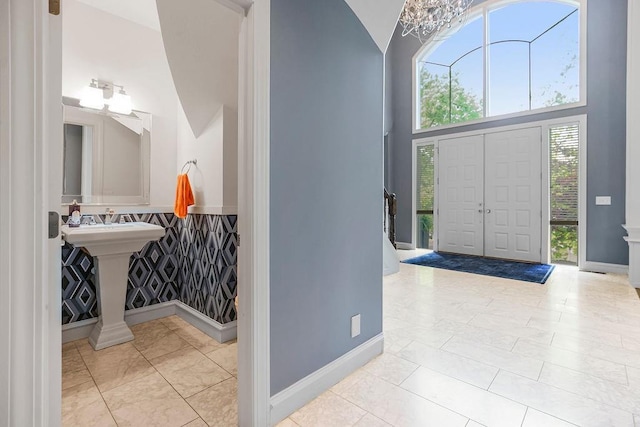 tiled entryway with a high ceiling