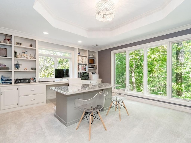 carpeted office space featuring ornamental molding, a raised ceiling, and a chandelier