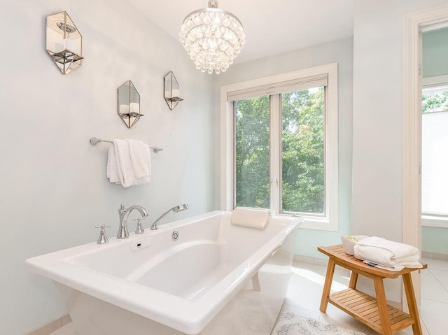 bathroom featuring a bath, tile patterned floors, and a chandelier