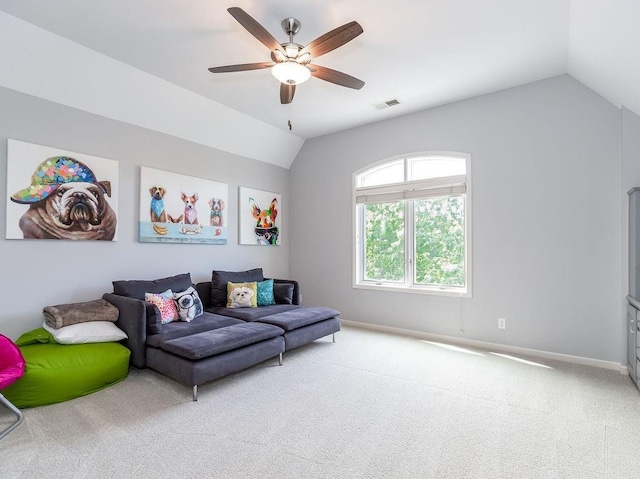 carpeted living room featuring vaulted ceiling and ceiling fan