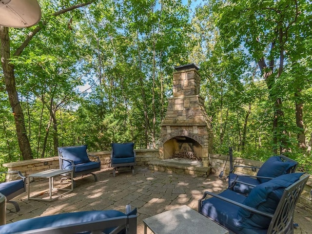 view of patio / terrace with an outdoor living space with a fireplace