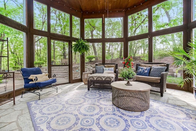 sunroom featuring plenty of natural light and wooden ceiling