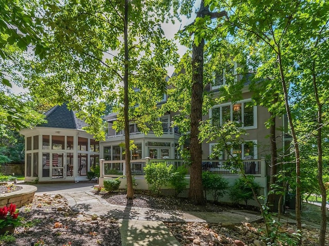 back of property with a sunroom