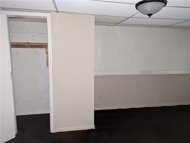 unfurnished bedroom featuring a drop ceiling