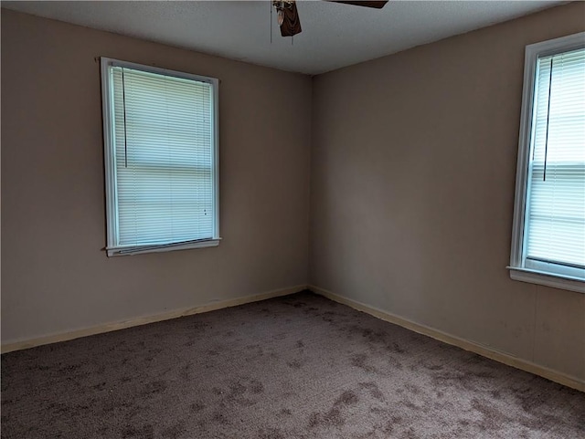 carpeted empty room featuring ceiling fan