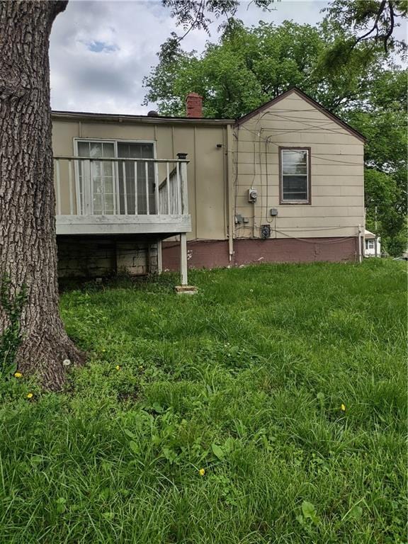 rear view of property featuring a yard