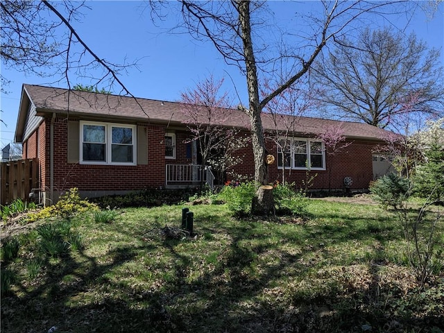 rear view of house featuring a yard