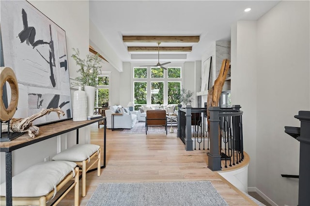 interior space with beamed ceiling and light hardwood / wood-style flooring