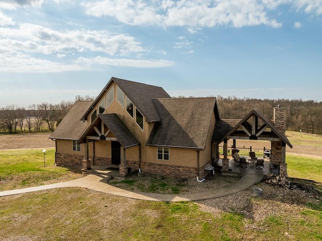 craftsman-style house featuring a patio area and a front lawn