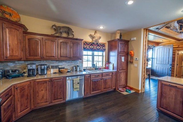 kitchen with light stone countertops, dark hardwood / wood-style flooring, sink, stainless steel dishwasher, and tasteful backsplash