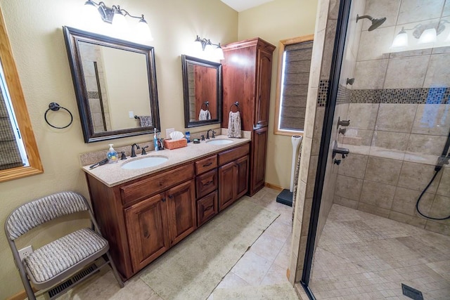 bathroom with tile flooring, a shower with door, oversized vanity, and dual sinks