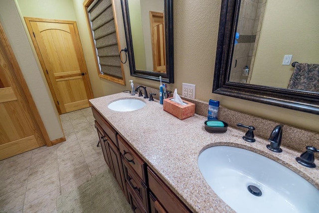 bathroom featuring tile floors and dual vanity