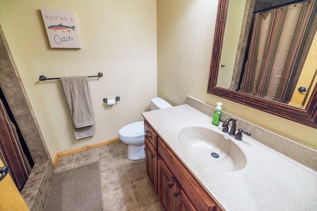 bathroom with vanity, toilet, and tile floors