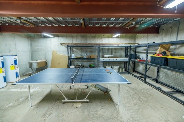 recreation room with concrete flooring and electric water heater