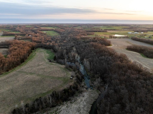 aerial view at dusk featuring a rural view