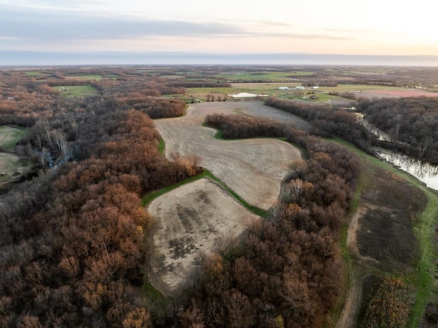 aerial view at dusk featuring a rural view