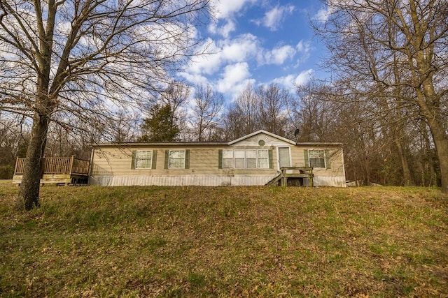 manufactured / mobile home featuring a front lawn and a deck