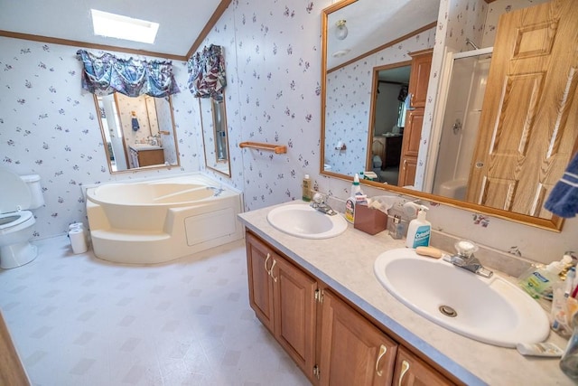 bathroom featuring dual vanity, a washtub, toilet, tile floors, and vaulted ceiling