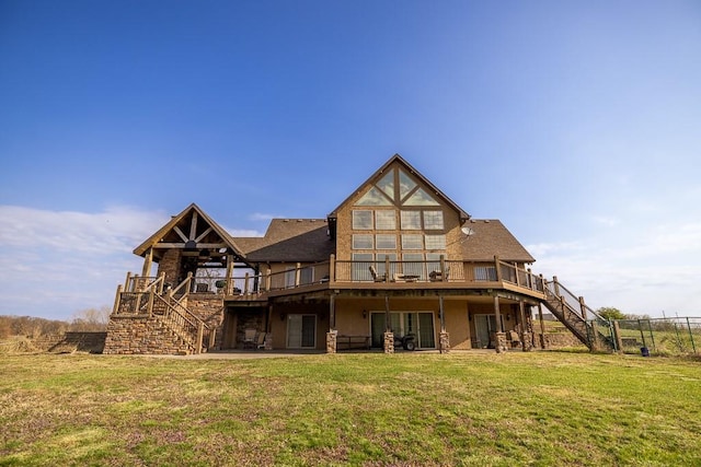 rear view of property with a wooden deck and a yard