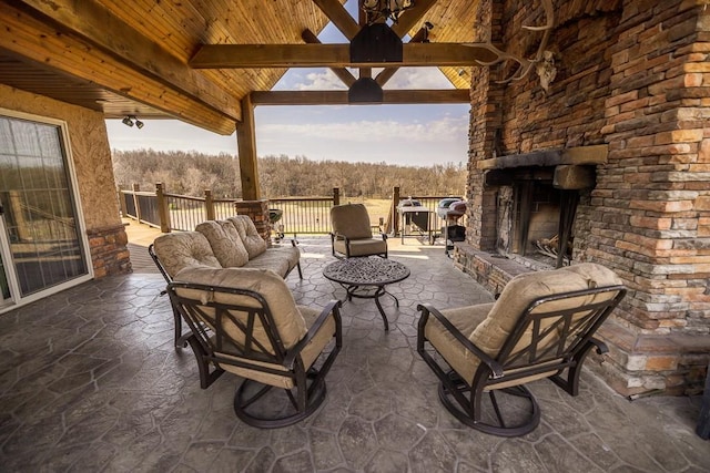 view of terrace with an outdoor living space with a fireplace