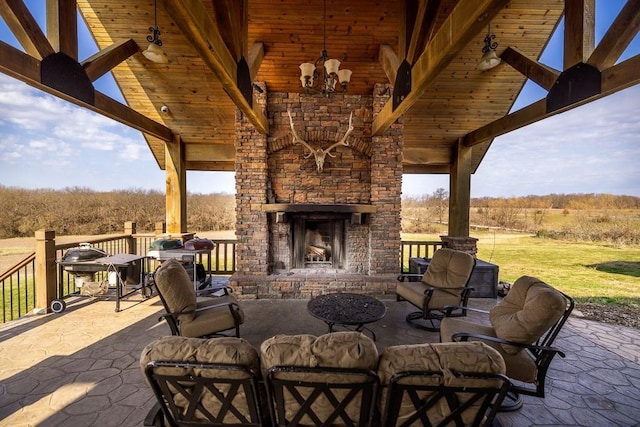 view of patio / terrace with a grill and an outdoor brick fireplace