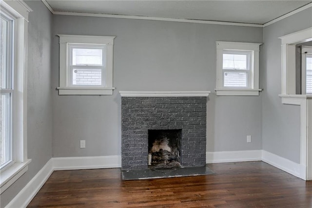 unfurnished living room with a brick fireplace, dark hardwood / wood-style flooring, and crown molding