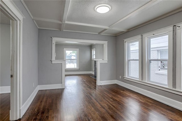 unfurnished room featuring coffered ceiling, a textured ceiling, and dark hardwood / wood-style floors