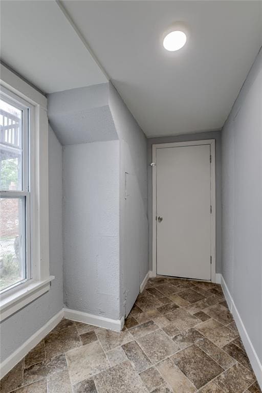 additional living space featuring tile floors and vaulted ceiling