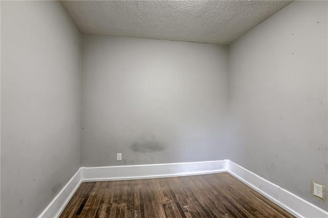 unfurnished room with hardwood / wood-style floors and a textured ceiling