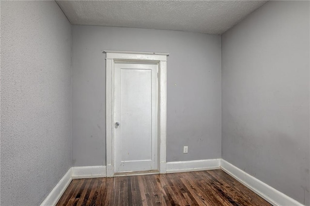 unfurnished room featuring a textured ceiling and wood-type flooring