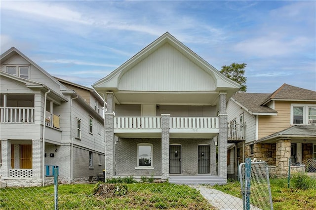 view of front of home featuring a front yard and a balcony