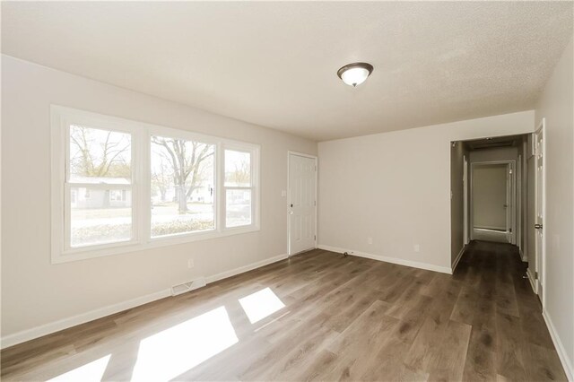 spare room with wood-type flooring