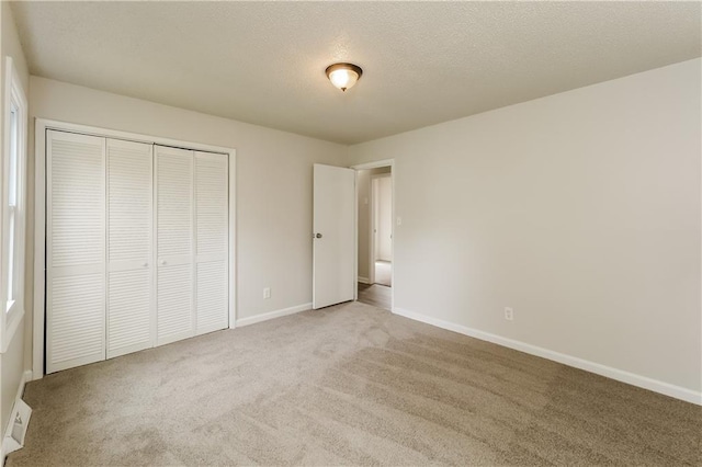 unfurnished bedroom featuring a closet and carpet flooring