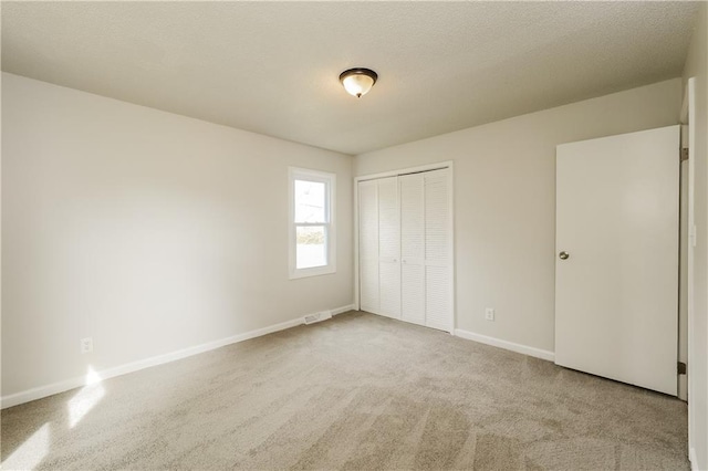 unfurnished bedroom with a closet and carpet