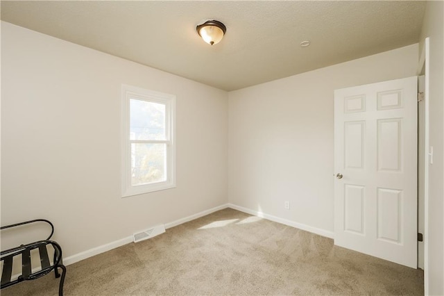 spare room featuring carpet