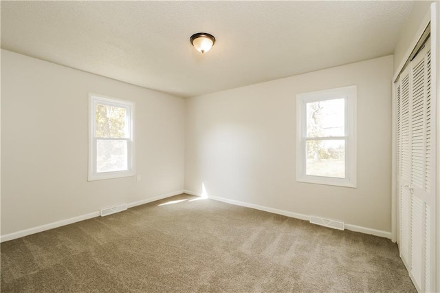 unfurnished bedroom featuring a closet and carpet