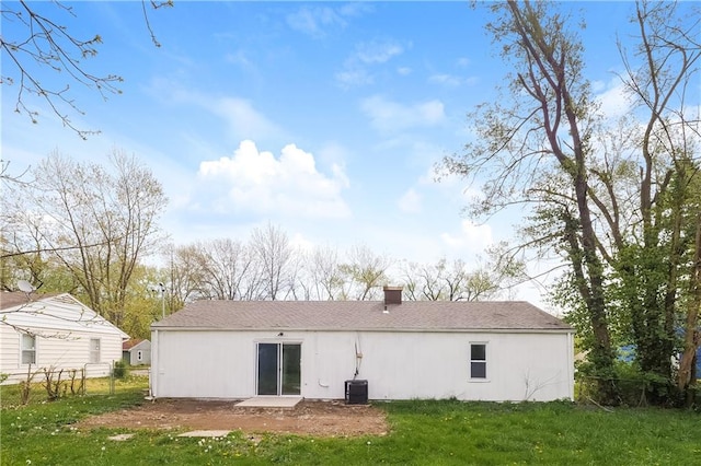 back of house featuring a yard and central AC unit