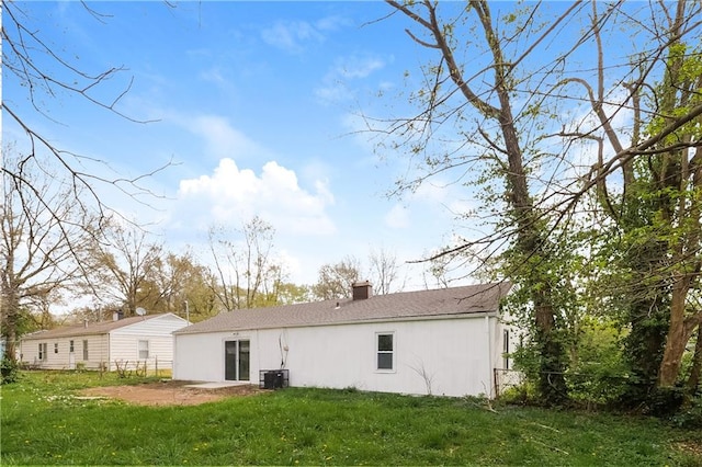 back of house featuring a patio area, a yard, and central AC