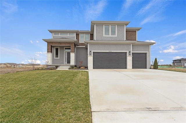 prairie-style home featuring a front lawn and a garage