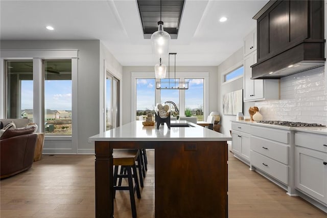 kitchen with pendant lighting, a center island, plenty of natural light, and stainless steel gas stovetop