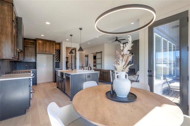 dining area with ceiling fan and light wood-type flooring