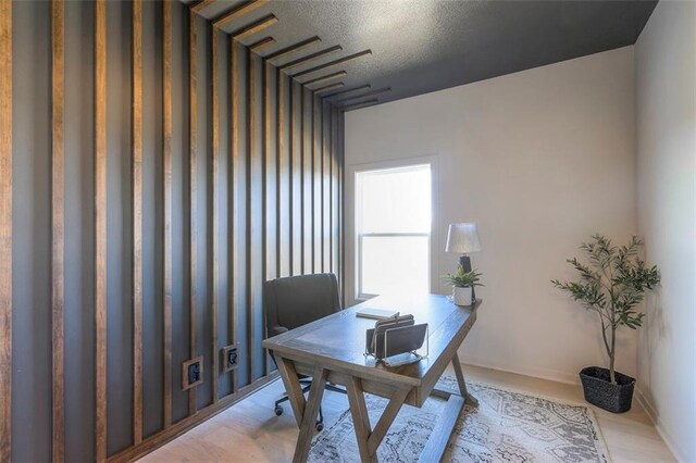 home office with light hardwood / wood-style floors