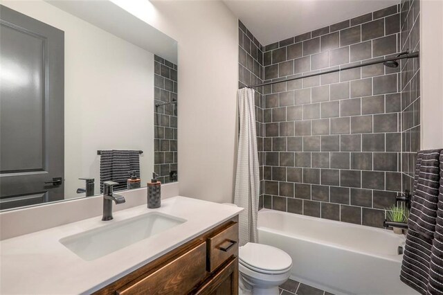 full bathroom featuring vanity, shower / bath combo with shower curtain, toilet, and tile patterned flooring