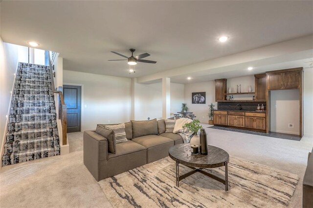 living room with light carpet and ceiling fan